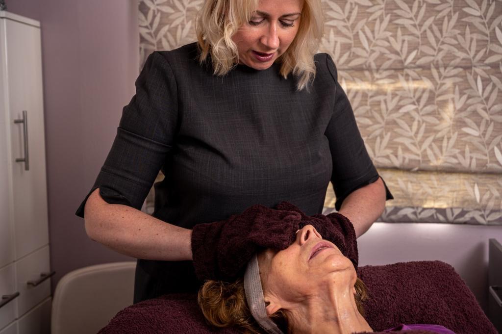 The Skinologist - Fiona performing a facial treatment with mitts on a client at the Chester Skin clinic